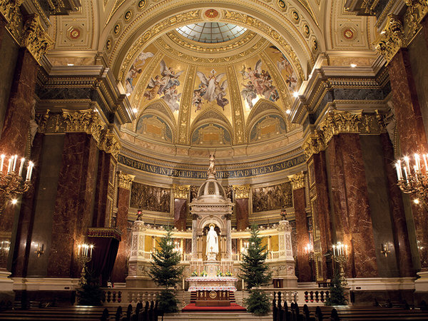 In the magnificent interior of Budapest's largest church, St Stephen's Basilica, line arrays in column design are installed in the same shade of red as the wall colour.