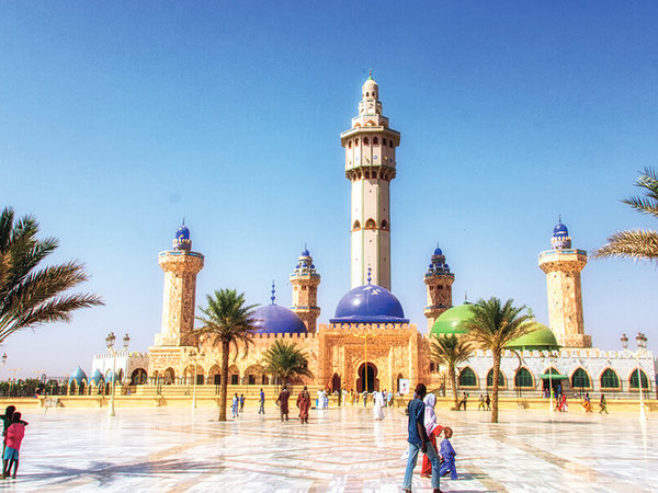 Vom Vorplatz der Großen Moschee von Touba im Senegal ist das größte Gebäude in der Stadt gut zu sehen. In der Moschee mit den 5 hohen Minaretten und blauen und grünfarbenenen Kuppeln sind aktive, digital steuerbare Linienstrahler aus der Pan Beam Serie installiert.