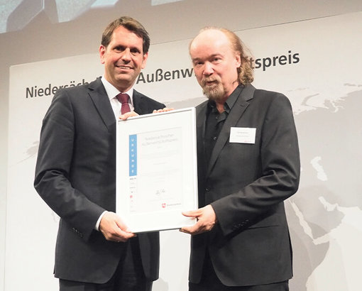 The Minister for Economic Affairs in Lower Saxony, Olaf Lies, presents Udo Borgmann, founder and Managing Director of Pan Acoustics GmbH, with the nomination certificate for the Lower Saxony Foreign Trade Award 2017 at the Hannover Messe.